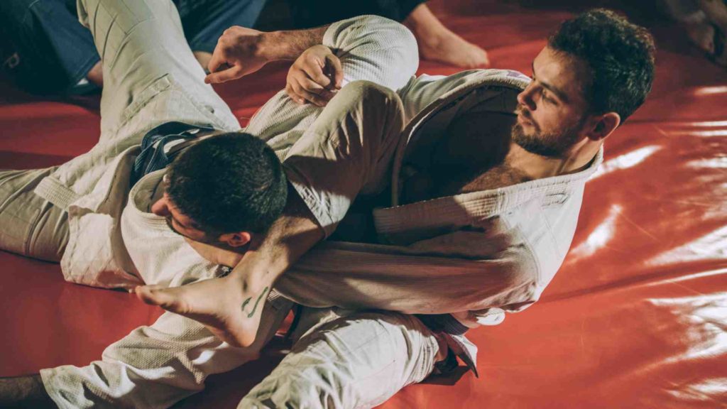 Image of men practicing jujitsu - in reference to how physical competition can increase testosterone levels.
