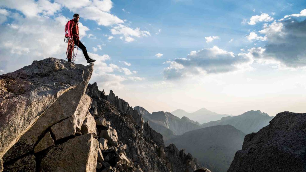 Image of a man overlooking a mountain range, thinking about semen retention.