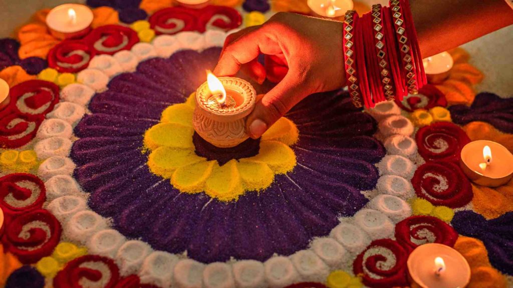 Image of a candle in a Tantric ritual with flowers.