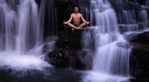 Photo of Taylor Johnson on a waterfall in Asheville practicing semen retention.