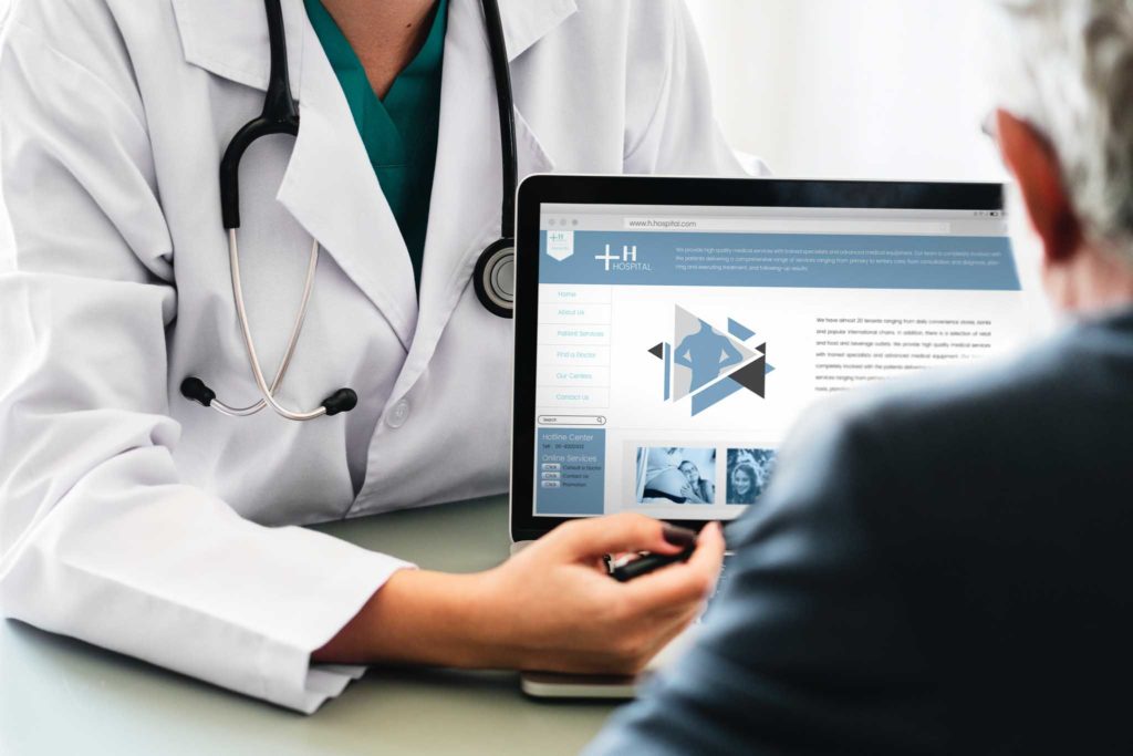 Photo of a doctor showing a diagram to a patient.