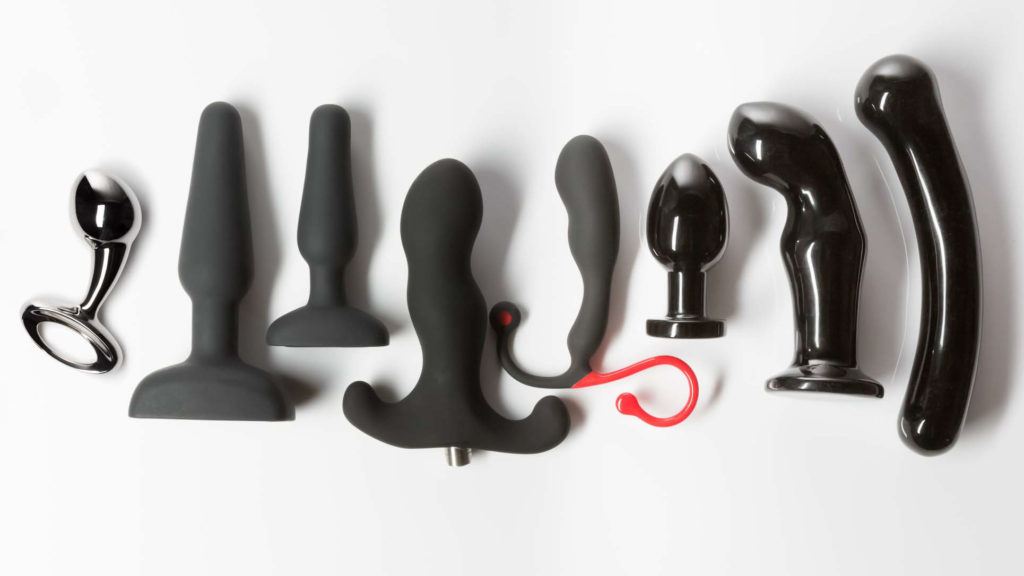 Photo of a row of anal toys for men, including butt plugs, prostate massagers and more.