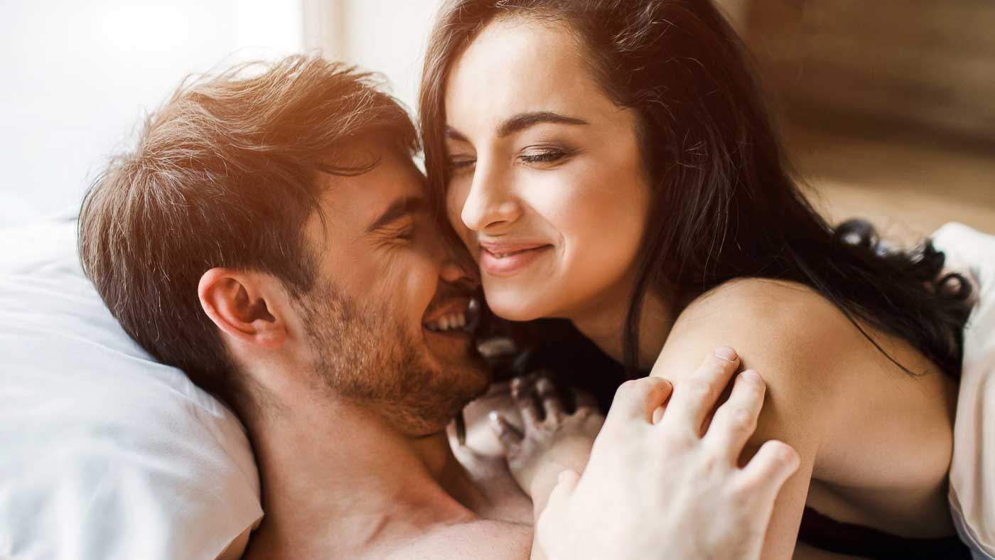 photo of a happy couple in bed together