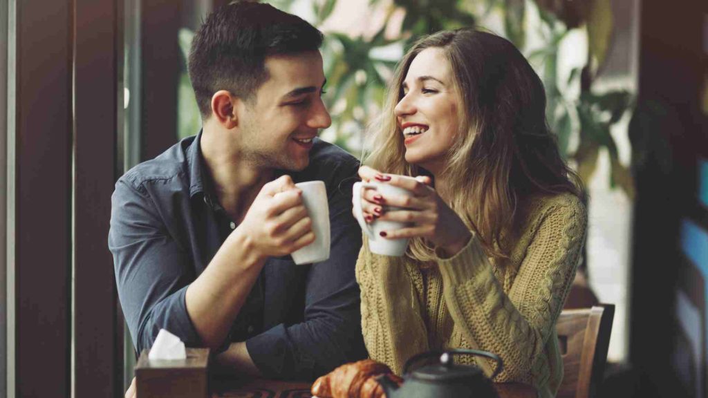 Image of a couple talking in a coffee shop.