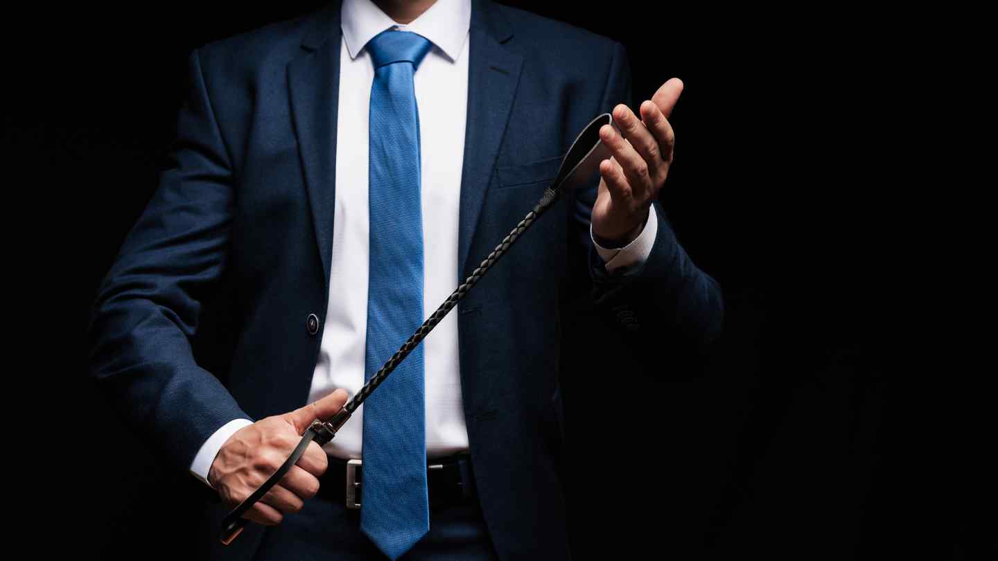 Photo of a man holding a spanking implement to represent the concept of Sadism.