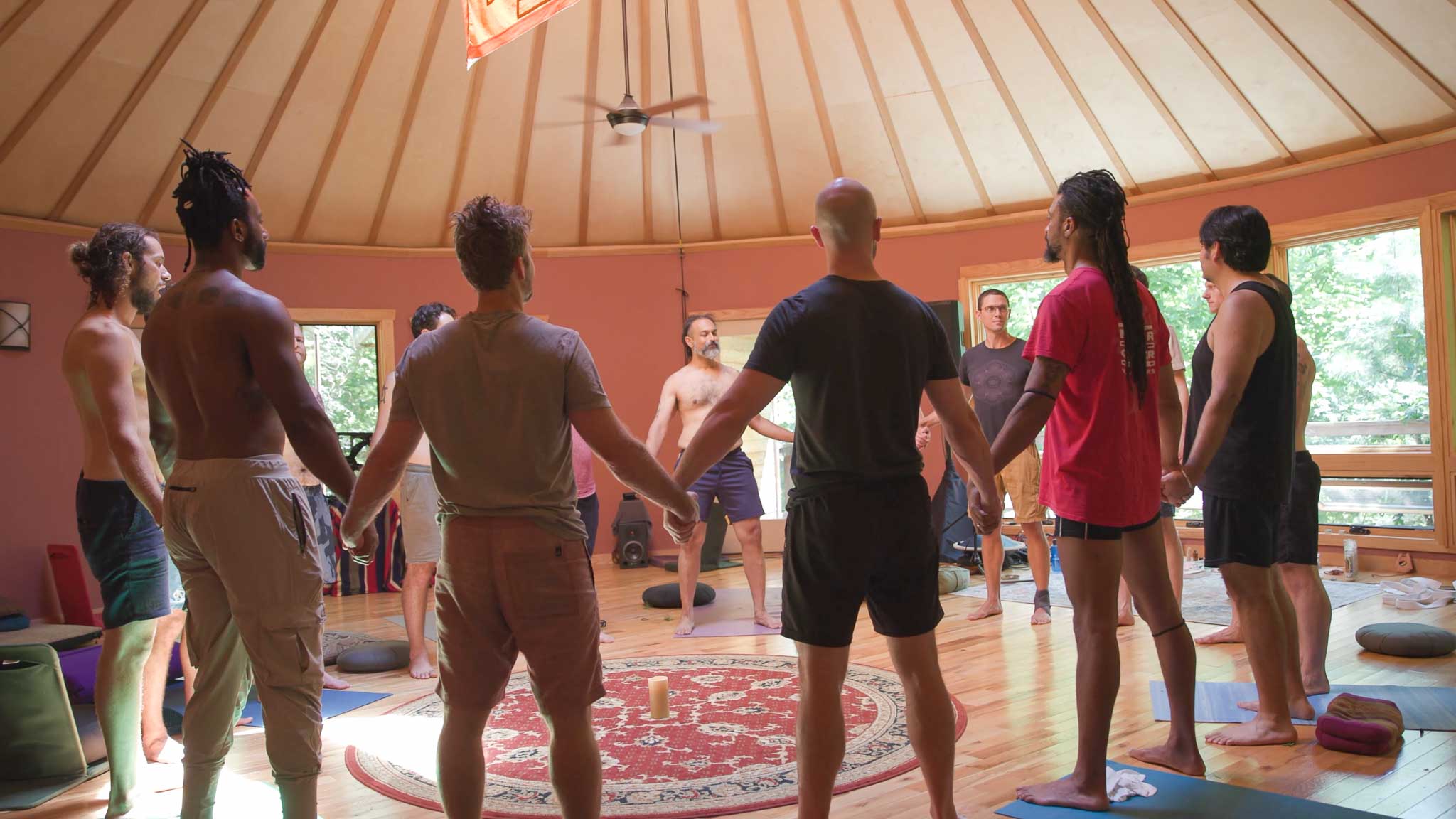 Group photo of men watching Taylor teach at a men's retreat.